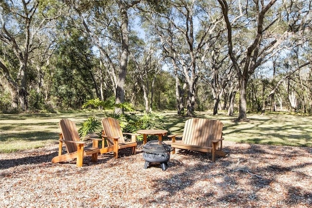 view of yard with an outdoor fire pit