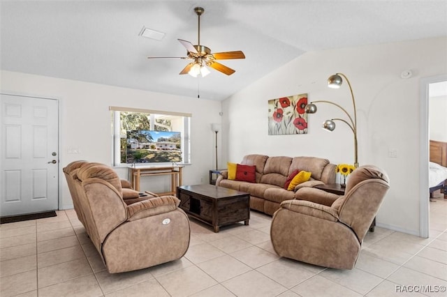 tiled living room featuring ceiling fan and vaulted ceiling