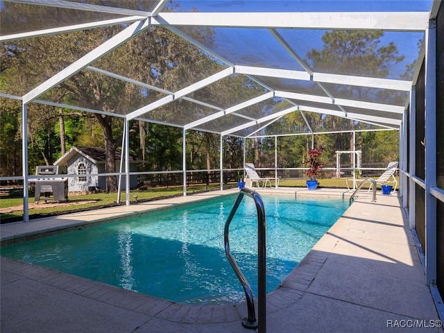 view of pool with a lanai and a patio area