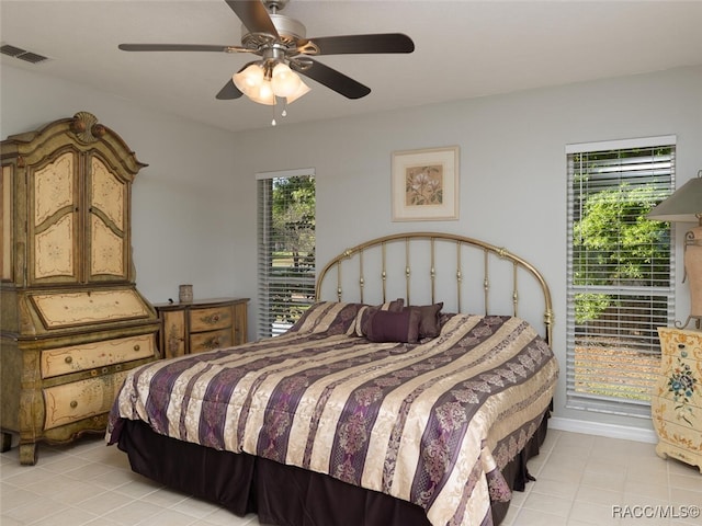 bedroom with ceiling fan and light tile patterned floors