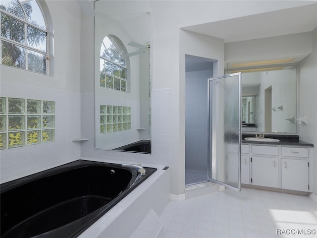 bathroom featuring tile patterned flooring, vanity, and independent shower and bath