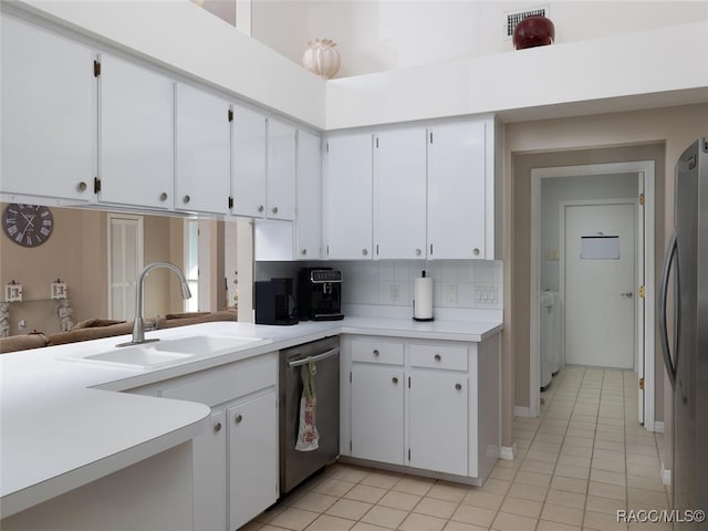 kitchen with white cabinetry, sink, light tile patterned floors, and appliances with stainless steel finishes