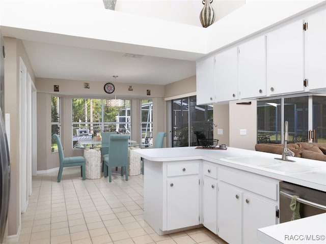 kitchen featuring light tile patterned floors, white cabinetry, stainless steel dishwasher, and sink