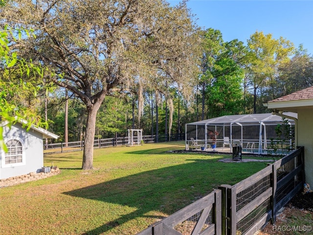 view of yard featuring glass enclosure