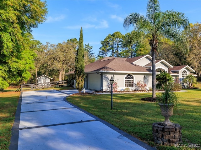 single story home featuring a front yard and a garage