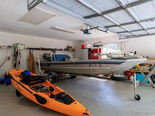 garage with a garage door opener and fridge