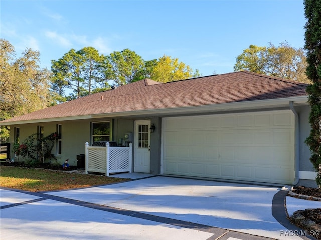 single story home featuring a porch and a garage