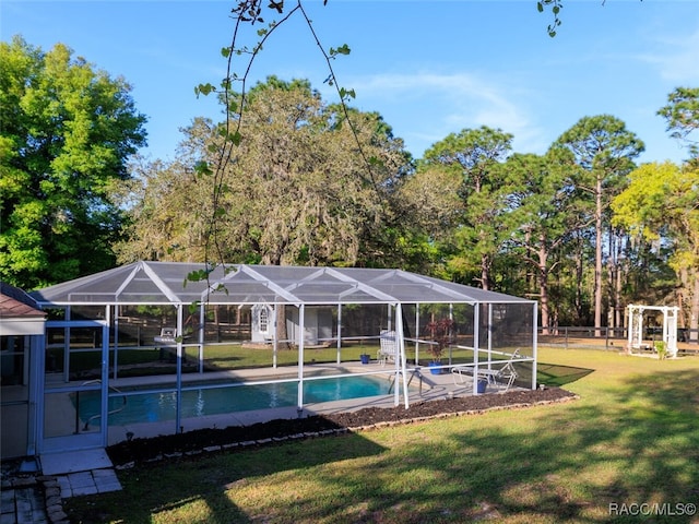 view of pool with a lanai and a yard