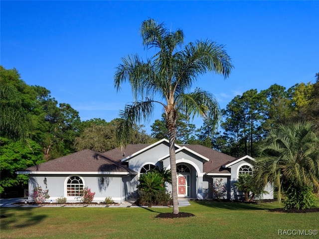 ranch-style home featuring a front yard