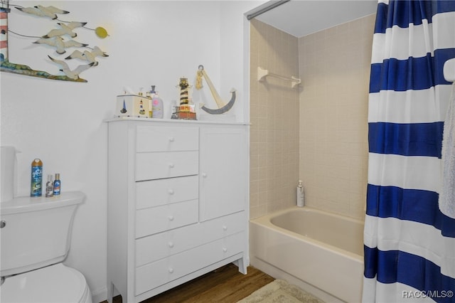 bathroom with toilet, wood-type flooring, and shower / tub combo