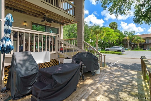 wooden terrace featuring area for grilling and ceiling fan