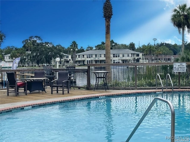 view of swimming pool featuring a wooden deck