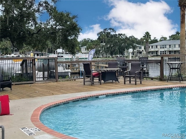 view of pool with a wooden deck