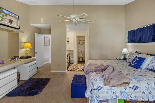 carpeted bedroom featuring ceiling fan and ensuite bathroom