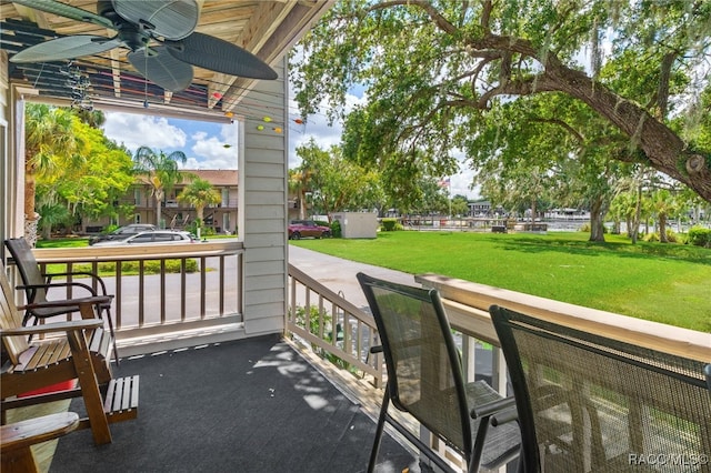 balcony featuring a porch and ceiling fan