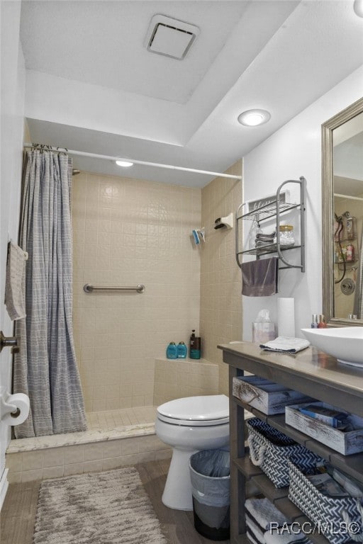 bathroom with tile patterned floors, sink, toilet, and walk in shower