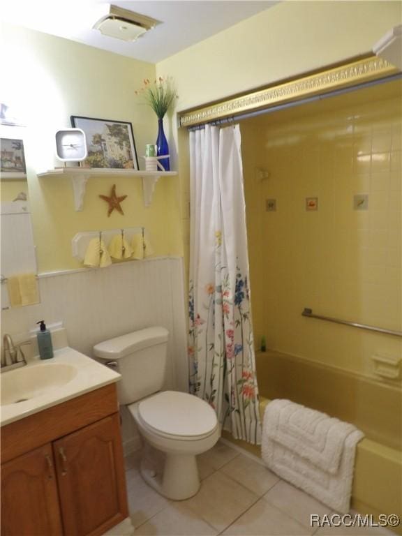 full bathroom with toilet, shower / bath combo with shower curtain, vanity, and tile patterned flooring