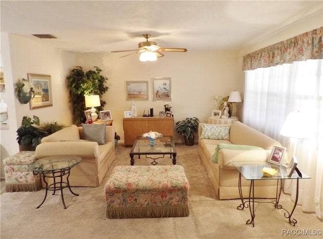 living room with light carpet and ceiling fan