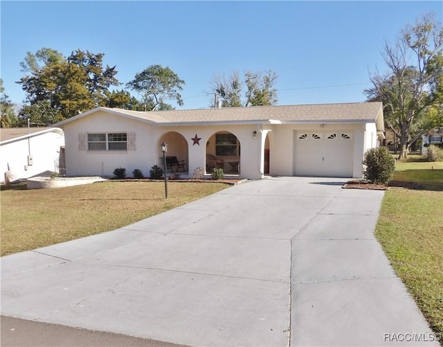 single story home featuring a garage and a front lawn