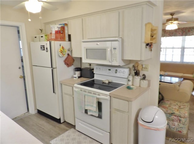 kitchen featuring white appliances and light hardwood / wood-style floors