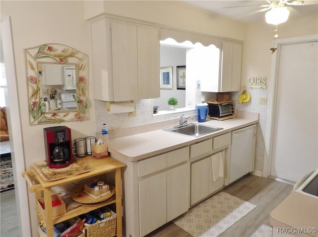 kitchen featuring ceiling fan, dishwasher, sink, tasteful backsplash, and light hardwood / wood-style floors