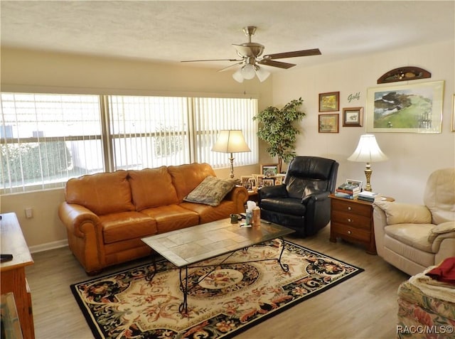 living room with light wood-type flooring and ceiling fan