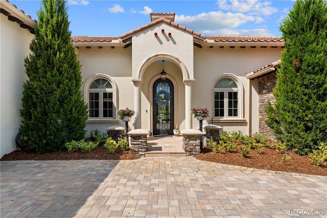 12380 SW 140th Loop, Dunnellon, FL 34432 - view of exterior entry with stucco siding and a tiled roof