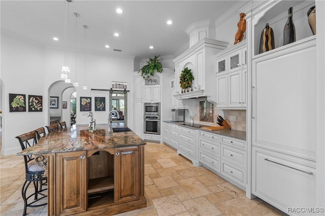12380 SW 140th Loop, Dunnellon, FL 34432 - kitchen with stone tile flooring, stainless steel appliances, a sink, recessed lighting, and arched walkways