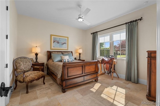 12380 SW 140th Loop, Dunnellon, FL 34432 - bedroom featuring stone tile flooring, baseboards, and a ceiling fan