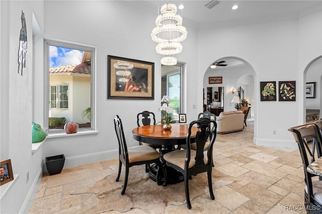 12380 SW 140th Loop, Dunnellon, FL 34432 - dining room with stone tile floors, arched walkways, recessed lighting, crown molding, and a high ceiling
