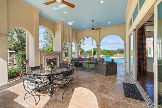12380 SW 140th Loop, Dunnellon, FL 34432 - view of patio with a ceiling fan, an outdoor pool, outdoor dining space, and an outdoor living space with a fireplace