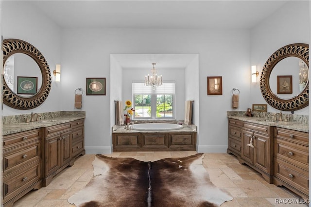 12380 SW 140th Loop, Dunnellon, FL 34432 - bathroom with stone tile flooring, a chandelier, baseboards, and a bath