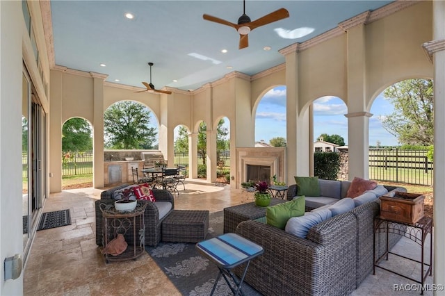 12380 SW 140th Loop, Dunnellon, FL 34432 - view of patio with an outdoor kitchen, ceiling fan, fence, outdoor dining area, and an outdoor living space with a fireplace