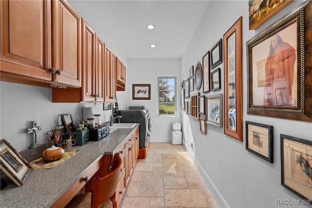 12380 SW 140th Loop, Dunnellon, FL 34432 - kitchen featuring stone tile floors, baseboards, separate washer and dryer, recessed lighting, and stone countertops