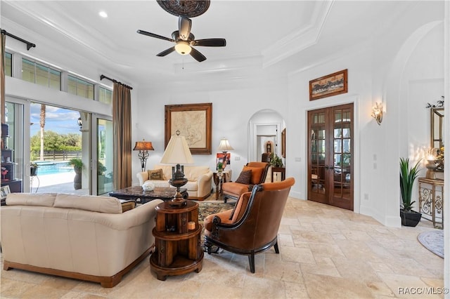 12380 SW 140th Loop, Dunnellon, FL 34432 - living room with arched walkways, stone tile floors, plenty of natural light, a raised ceiling, and ornamental molding