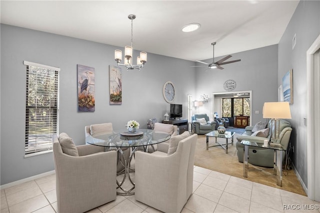 dining room with light tile patterned floors, a wealth of natural light, and vaulted ceiling