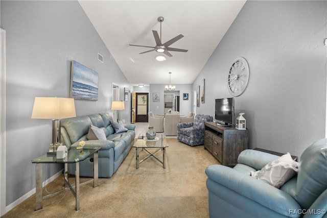 carpeted living room featuring lofted ceiling and ceiling fan with notable chandelier