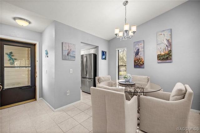 dining space with lofted ceiling, a notable chandelier, and light tile patterned flooring