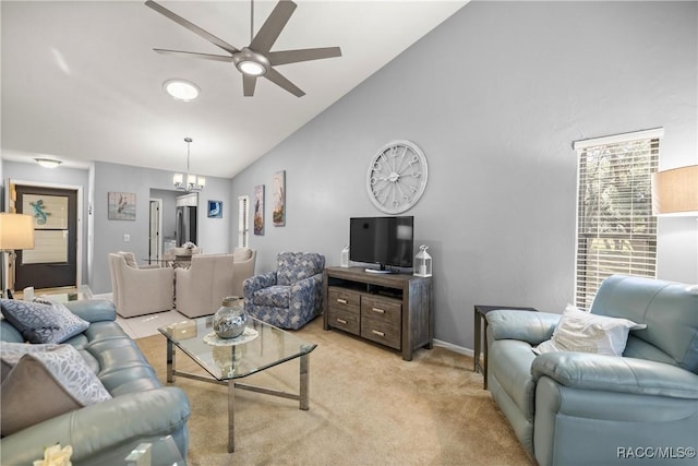 carpeted living room featuring lofted ceiling and ceiling fan with notable chandelier