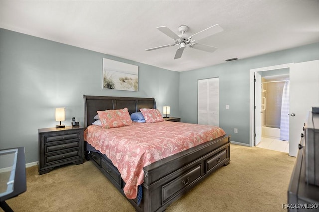 carpeted bedroom featuring ensuite bath, a closet, and ceiling fan