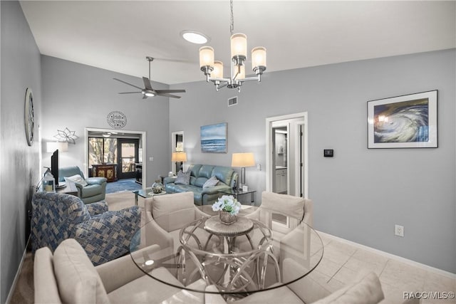 living room featuring lofted ceiling, ceiling fan with notable chandelier, and light tile patterned floors