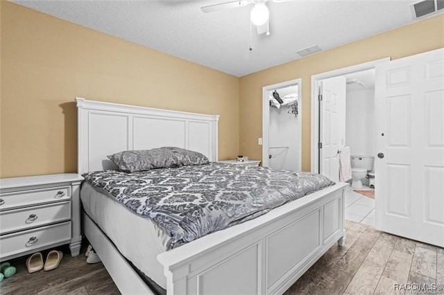 bedroom featuring ensuite bath, ceiling fan, and light wood-type flooring