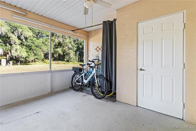 sunroom featuring ceiling fan