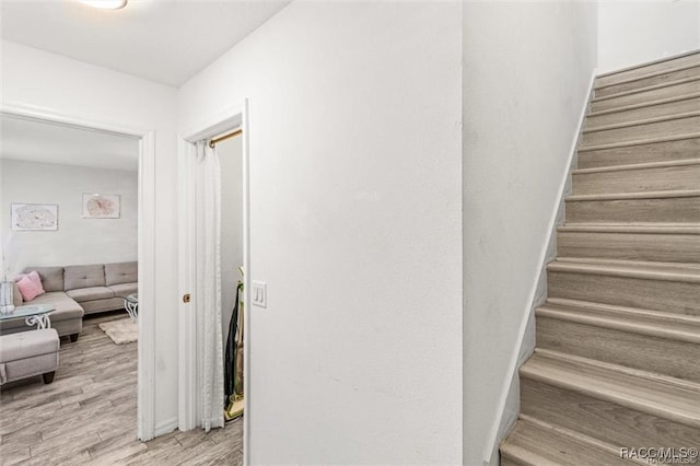 staircase with hardwood / wood-style flooring