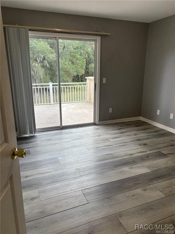 unfurnished room with light wood-type flooring