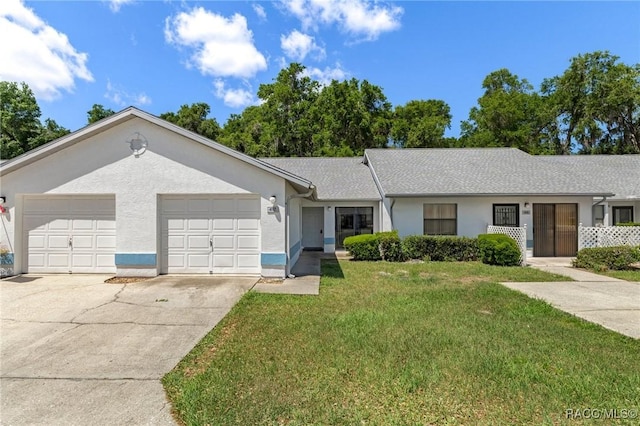 single story home with concrete driveway, stucco siding, an attached garage, and a front lawn