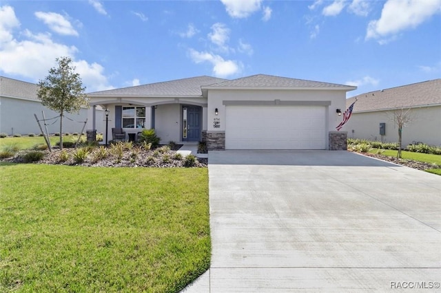 view of front of home featuring a front lawn, driveway, an attached garage, and stucco siding