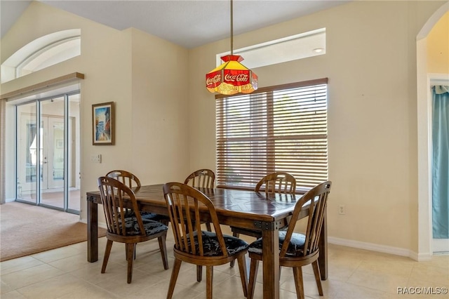 dining area featuring light tile patterned floors and french doors