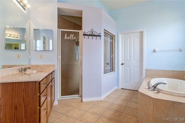 bathroom featuring tile patterned floors, vanity, and shower with separate bathtub