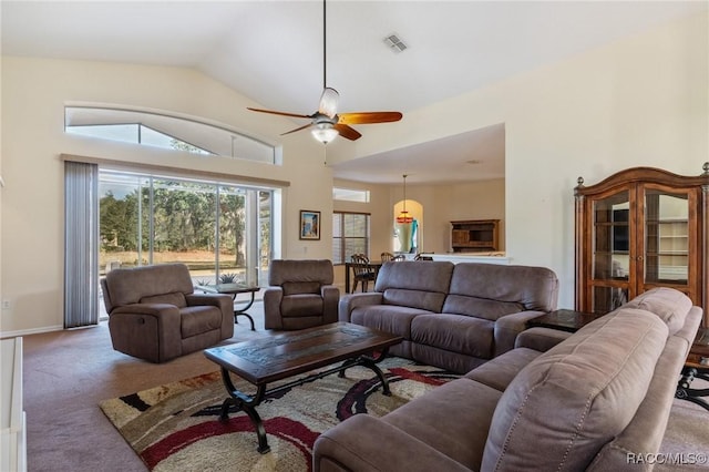 carpeted living room featuring vaulted ceiling and ceiling fan